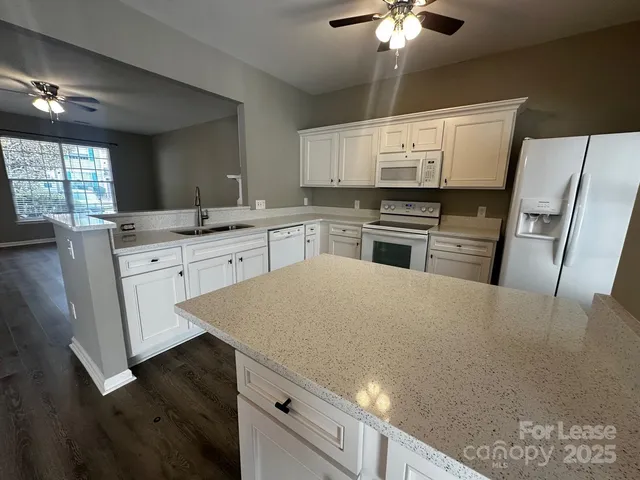 a kitchen with a stove a sink and a refrigerator