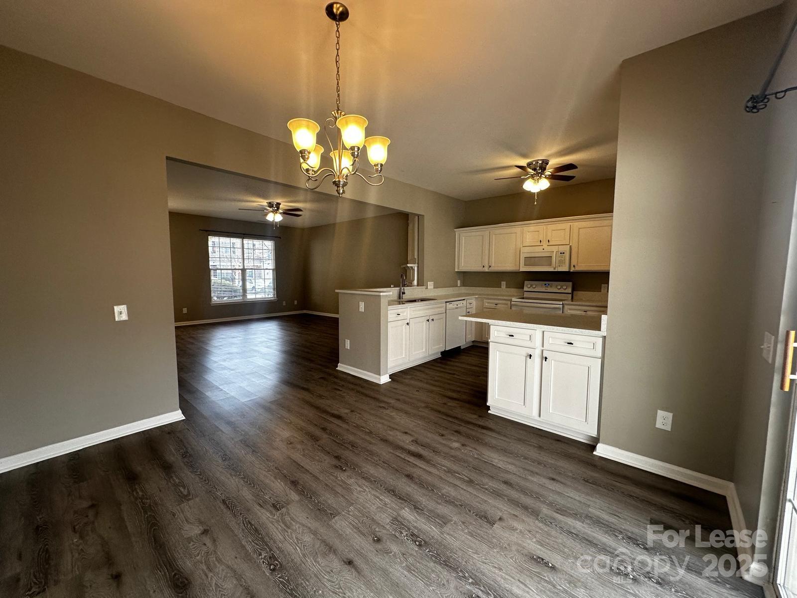 6828 Rothchild Drive Charlotte, NC 28270 - Photo 8 of 29 a view of a kitchen with a sink dishwasher a stove and wooden floor
