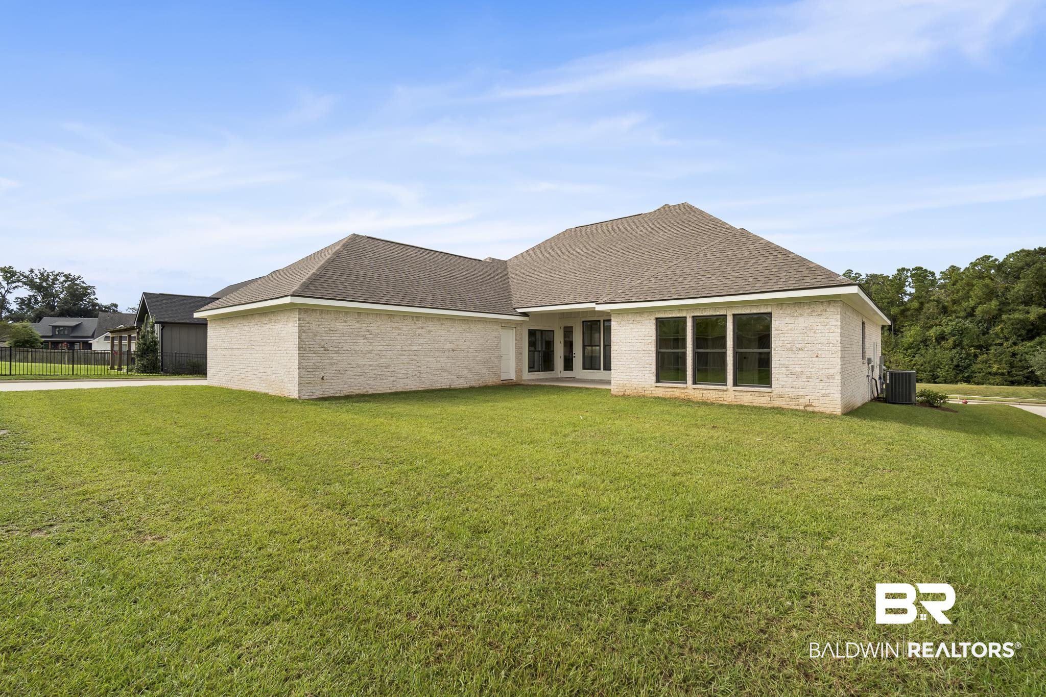 21826 Veranda Boulevard Fairhope, AL 36532 - Photo 33 of 42 Back of property featuring a shingled roof, a patio, and brick siding
