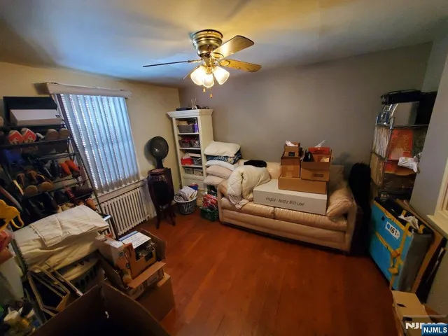 a living room with furniture a flat screen tv and a window