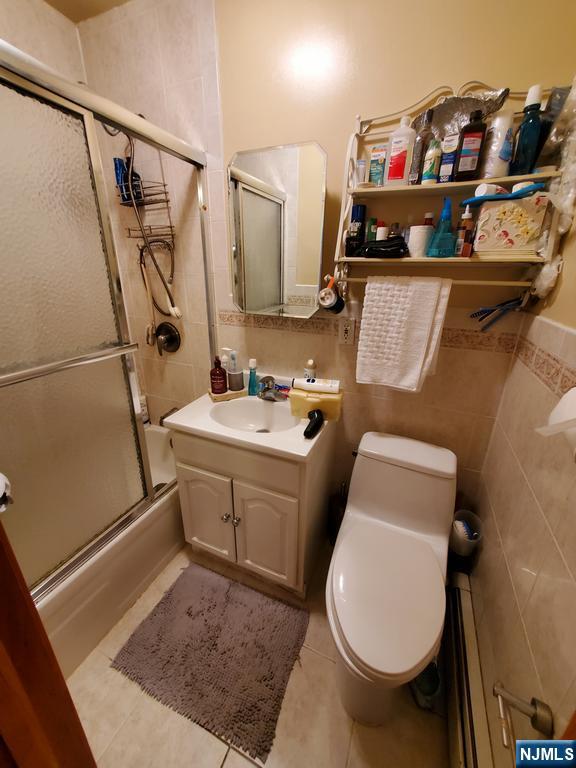 439 North 8th Street Fairview, NJ 07022 - Photo 2 of 20 a bathroom with sink and mirror