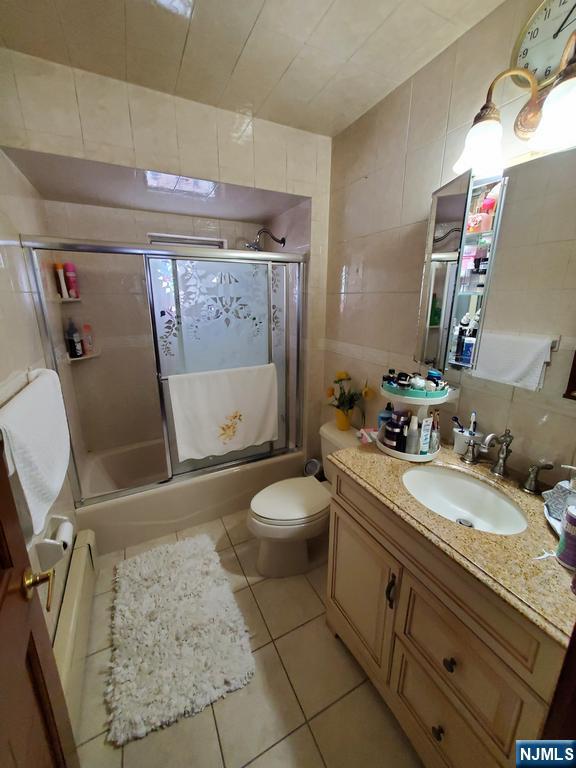 439 North 8th Street Fairview, NJ 07022 - Photo 5 of 20 a bathroom with a granite countertop sink toilet and shower