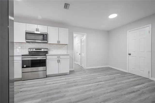 a kitchen with a stove and a microwave