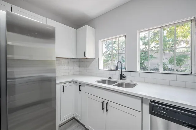 a kitchen with a sink and large window