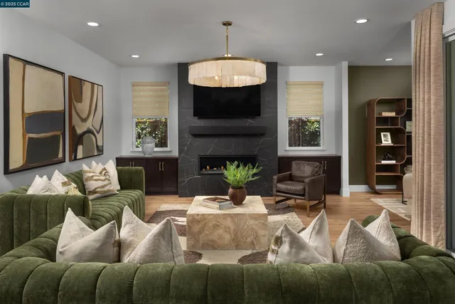 a living room with furniture a fireplace and a flat screen tv