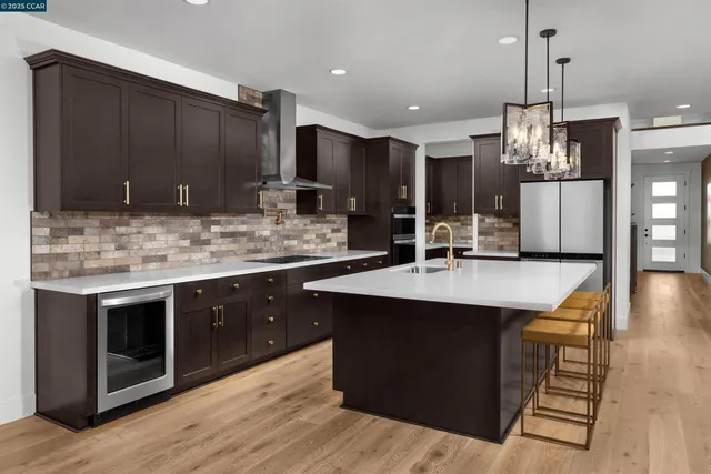 a kitchen with stainless steel appliances kitchen island granite countertop a sink and cabinets