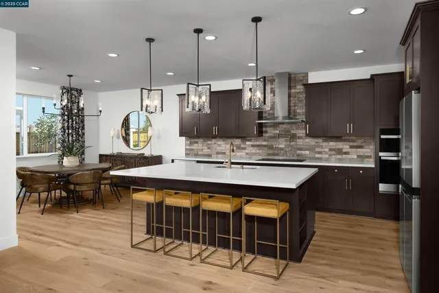 a kitchen with a table chairs sink and stove