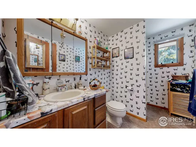 a kitchen with furniture and a clock