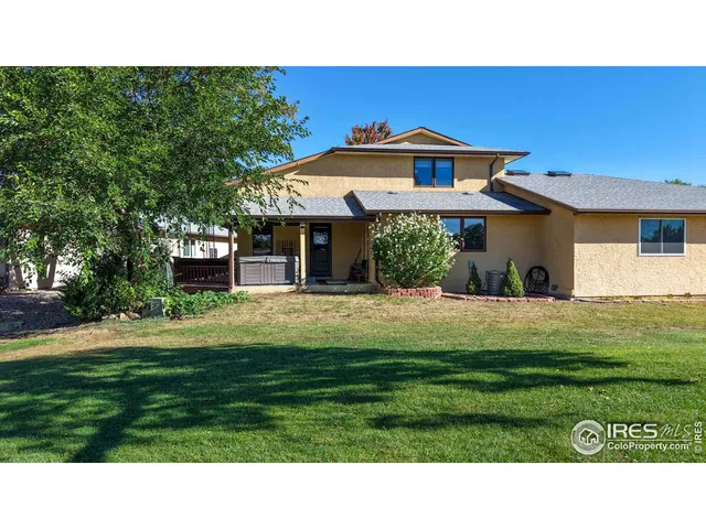 a view of a house with a backyard