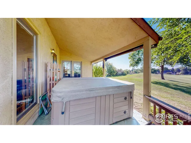 a view of a balcony with wooden floor and fence
