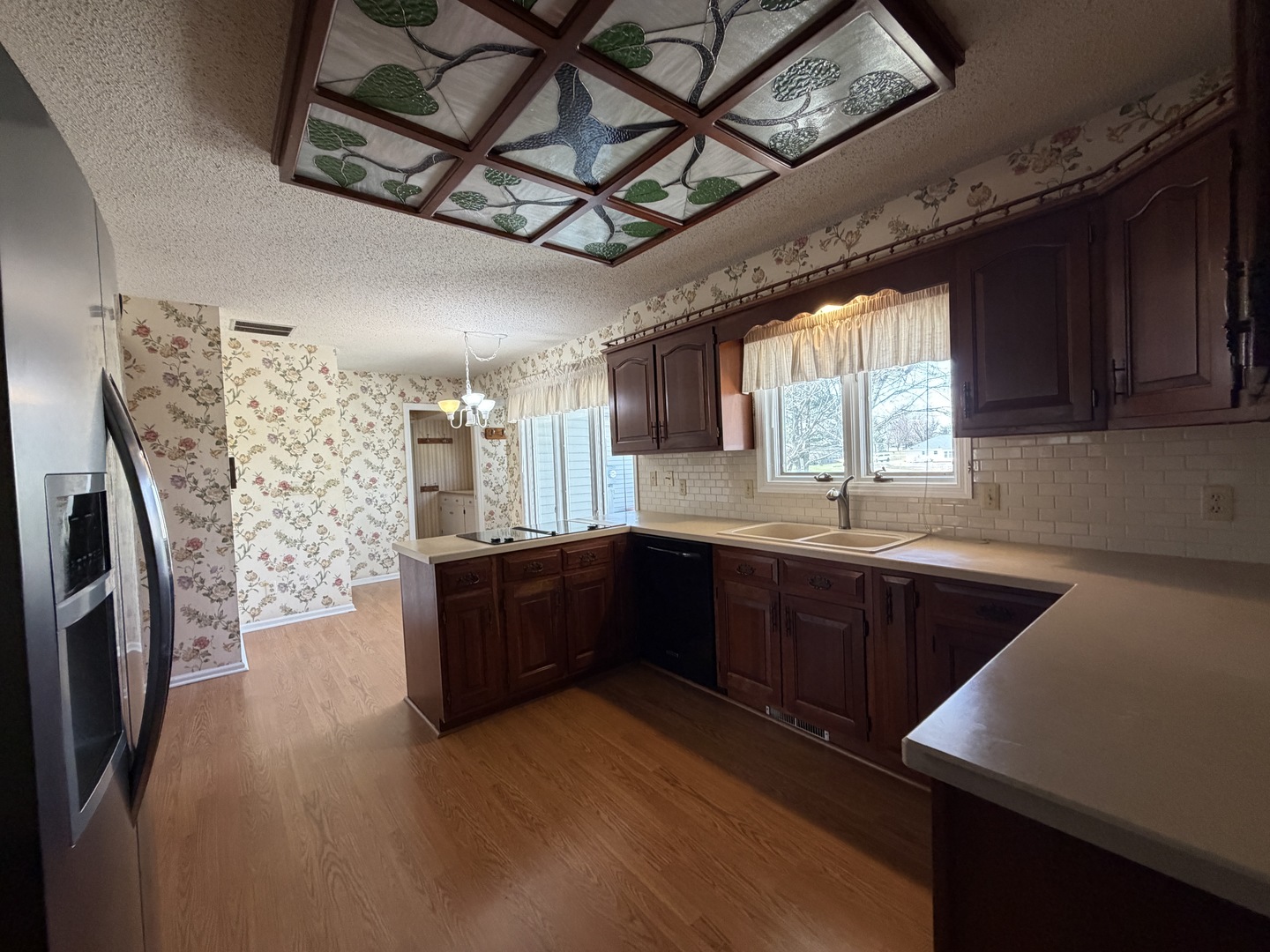 24 South Country Club Road Mattoon, IL 61938 - Photo 16 of 62 a large kitchen with stainless steel appliances granite countertop a refrigerator a sink dishwasher a stove and white countertops with wooden floor