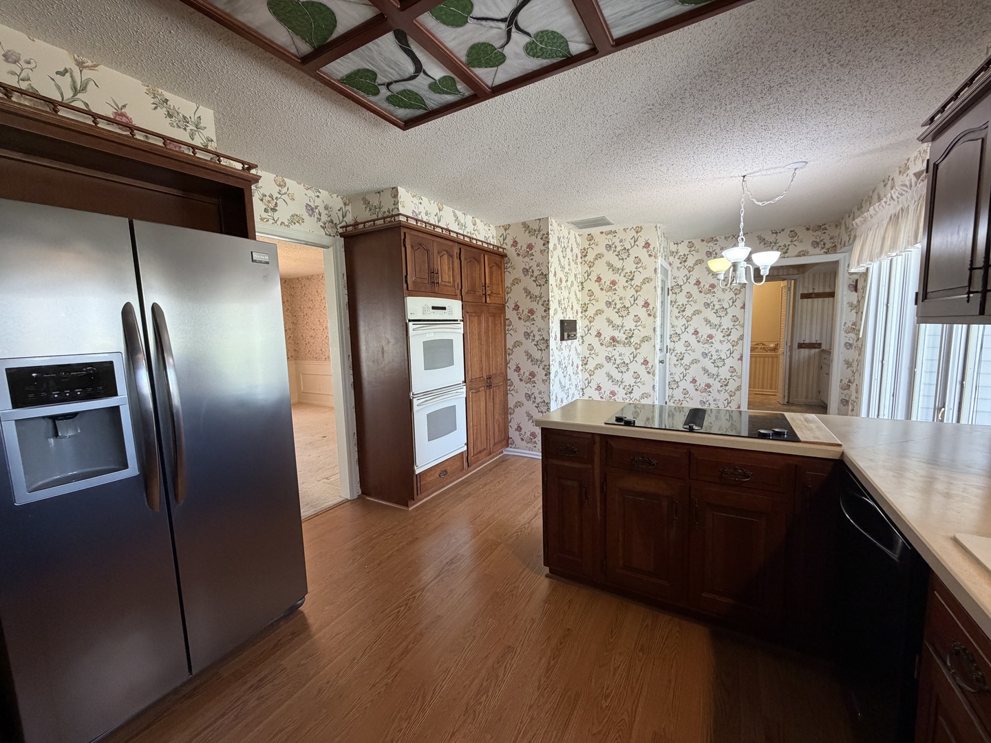 24 South Country Club Road Mattoon, IL 61938 - Photo 18 of 62 a kitchen with stainless steel appliances granite countertop a refrigerator and a wooden floors