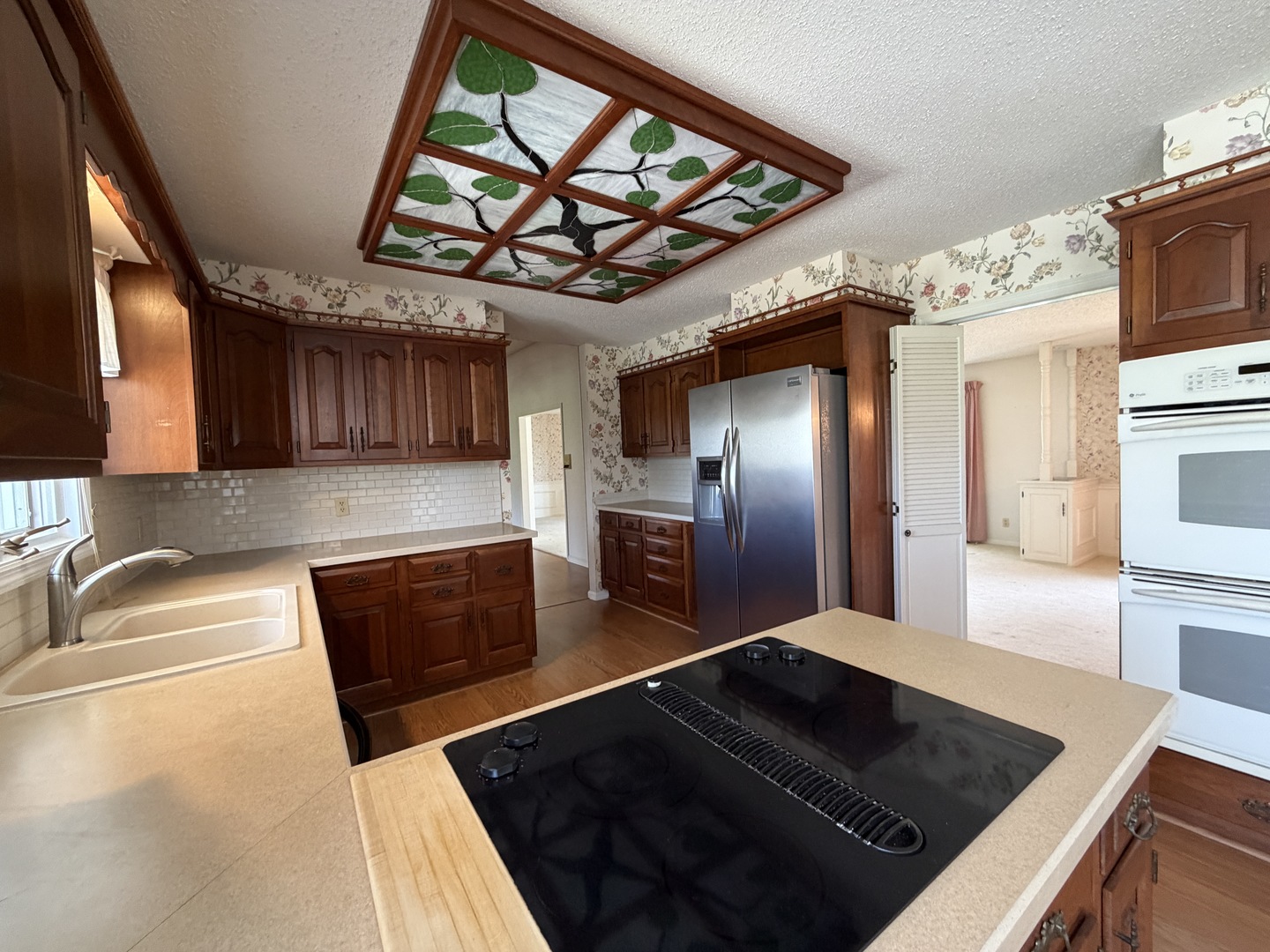 24 South Country Club Road Mattoon, IL 61938 - Photo 19 of 62 a kitchen with stainless steel appliances granite countertop a stove a sink and a microwave
