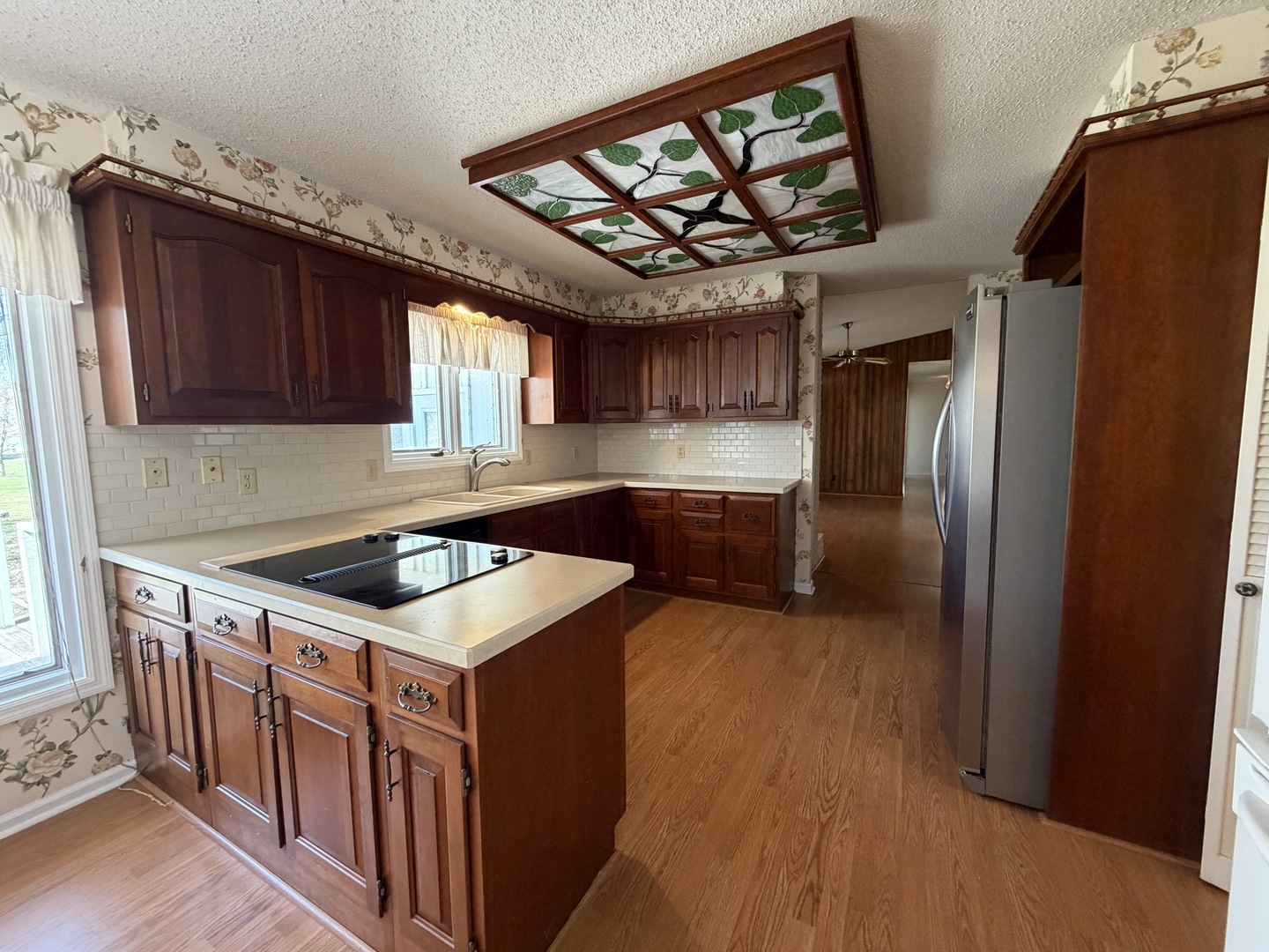 24 South Country Club Road Mattoon, IL 61938 - Photo 20 of 62 a kitchen that has a sink stainless steel appliances a window and cabinets