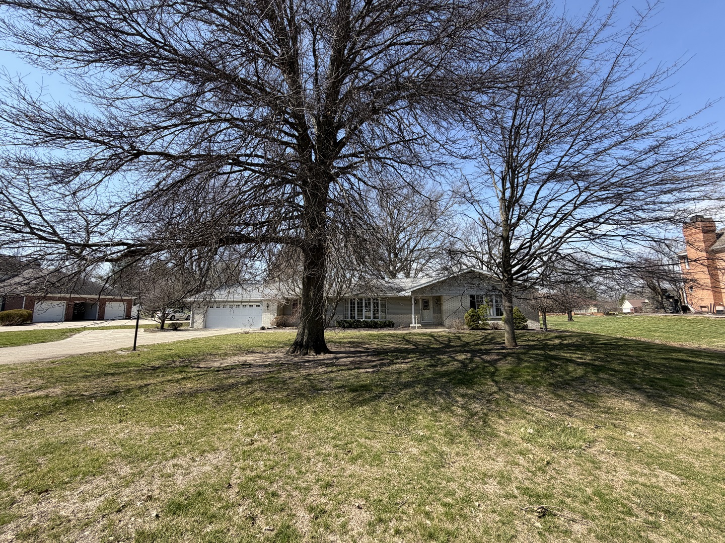 24 South Country Club Road Mattoon, IL 61938 - Photo 2 of 62 a house with trees in front of it