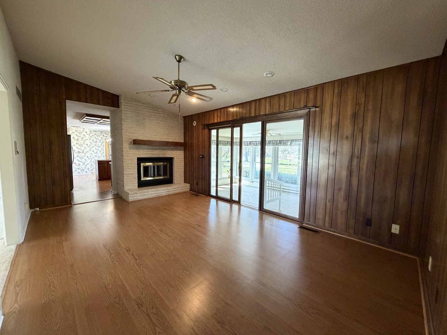 24 South Country Club Road Mattoon, IL 61938 - Photo 24 of 62 an empty room with windows fireplace and a ceiling fan