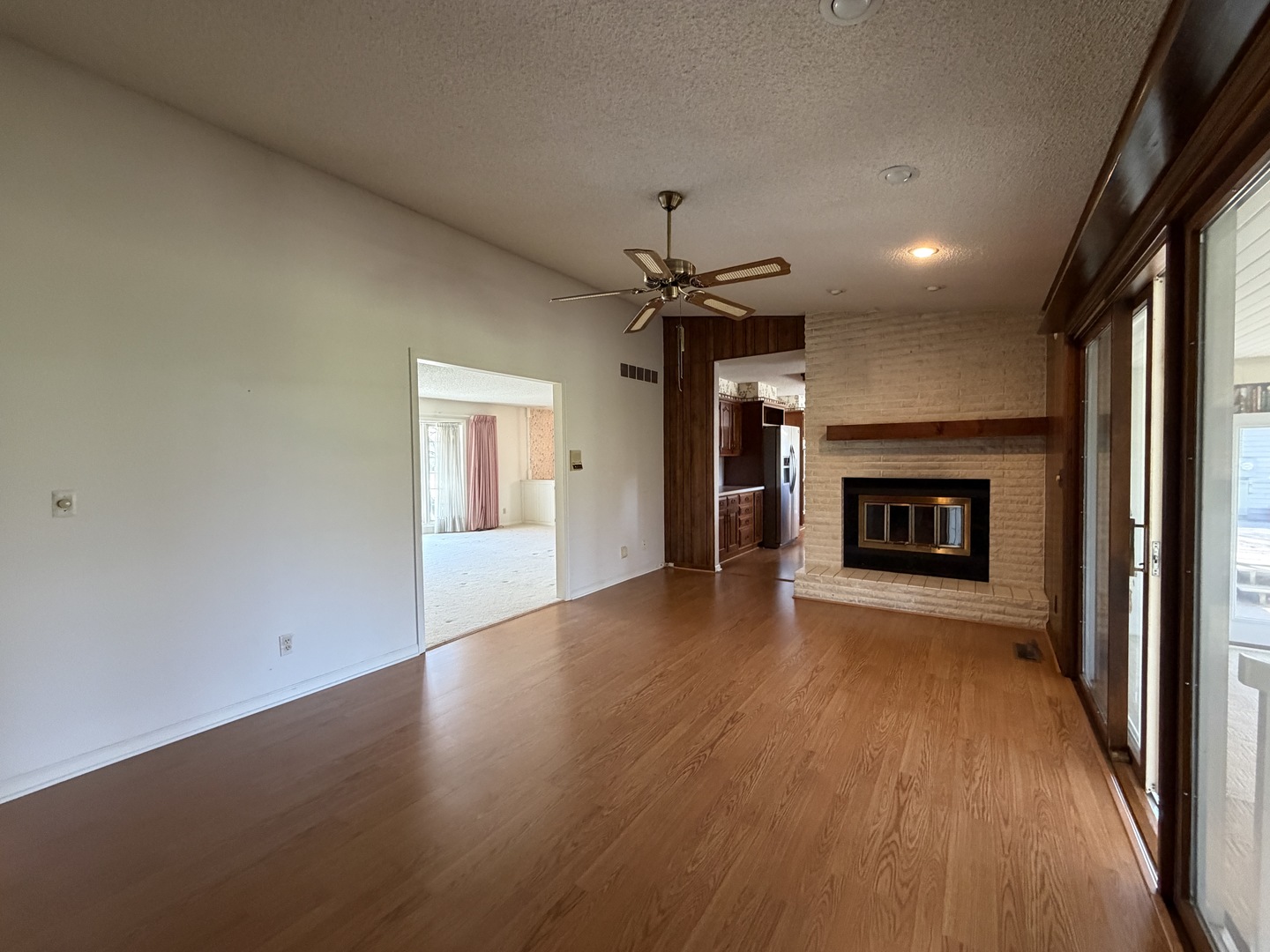 24 South Country Club Road Mattoon, IL 61938 - Photo 25 of 62 an empty room with wooden floor fireplace and windows