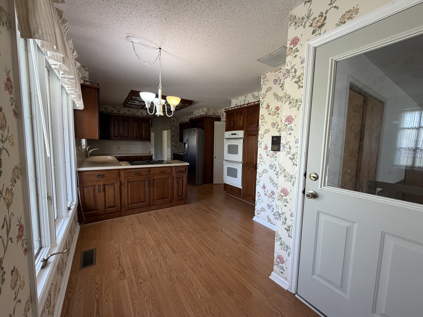 24 South Country Club Road Mattoon, IL 61938 - Photo 27 of 62 a kitchen with granite countertop a refrigerator and a wooden floor