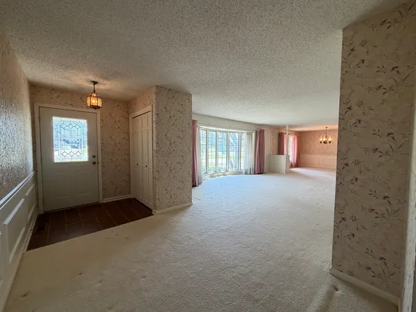 a view of an empty room with glass door
