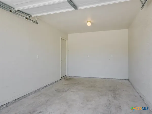 a view of a backyard with a garden and wooden fence