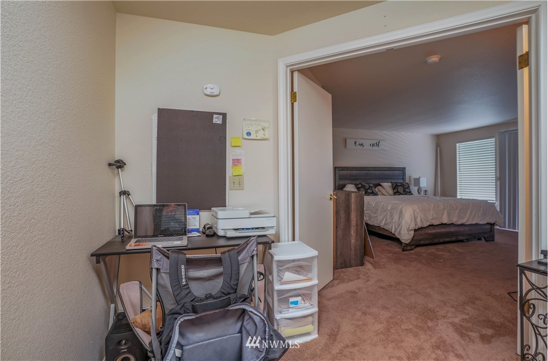 726 Roe Street Steilacoom, WA 98388 - Photo 13 of 29 a bedroom with a bed and a mirror