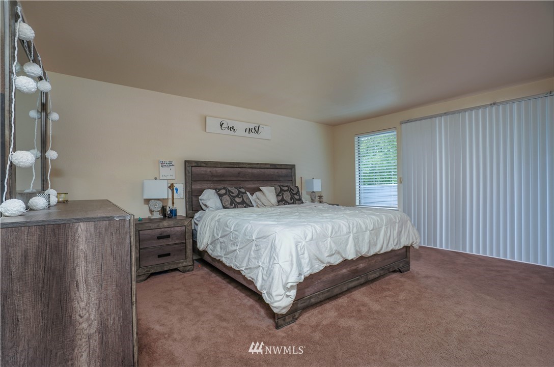 726 Roe Street Steilacoom, WA 98388 - Photo 14 of 29 a bed sitting in a bedroom next to a window