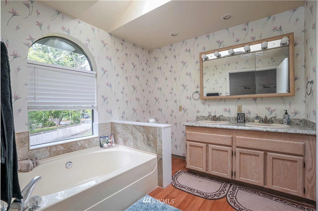 726 Roe Street Steilacoom, WA 98388 - Photo 15 of 29 a bathroom with a tub sink and mirror