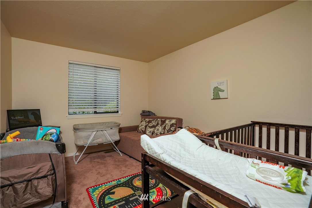 726 Roe Street Steilacoom, WA 98388 - Photo 17 of 29 a bedroom with furniture and a window