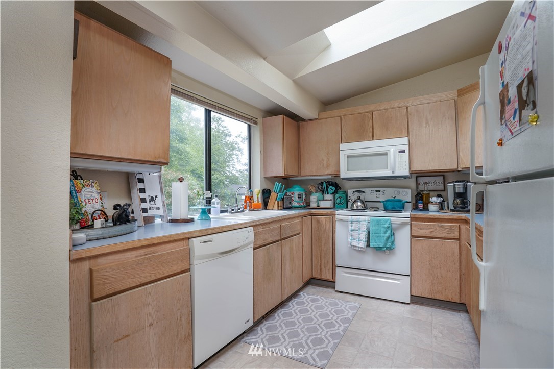 726 Roe Street Steilacoom, WA 98388 - Photo 20 of 29 a kitchen with white cabinets and white appliances