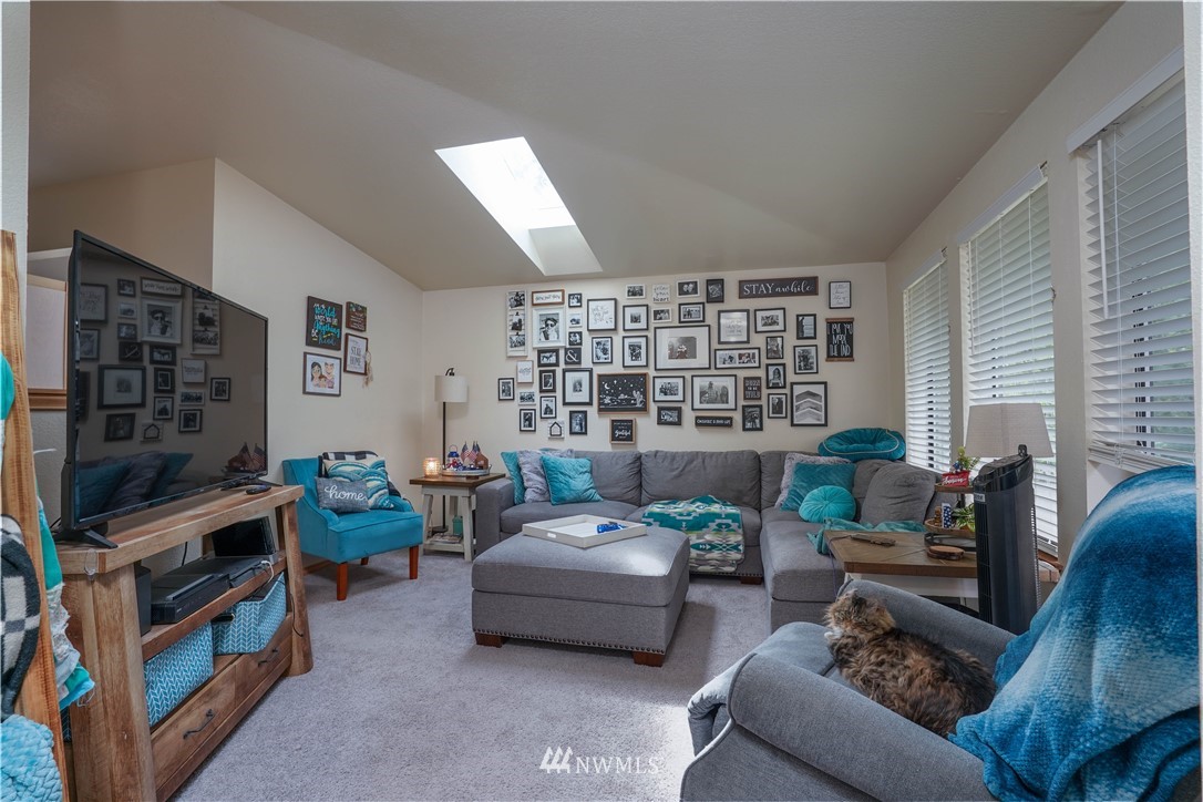 726 Roe Street Steilacoom, WA 98388 - Photo 25 of 29 a living room with furniture and a flat screen tv