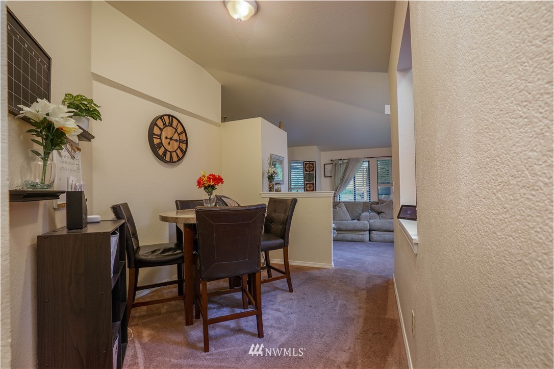 726 Roe Street Steilacoom, WA 98388 - Photo 8 of 29 a dining room with furniture potted plants and wooden floor