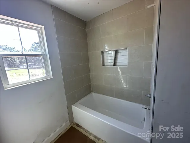 a white bath tub sitting next to a window