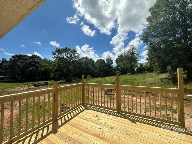 a view of a balcony with wooden floor and fence
