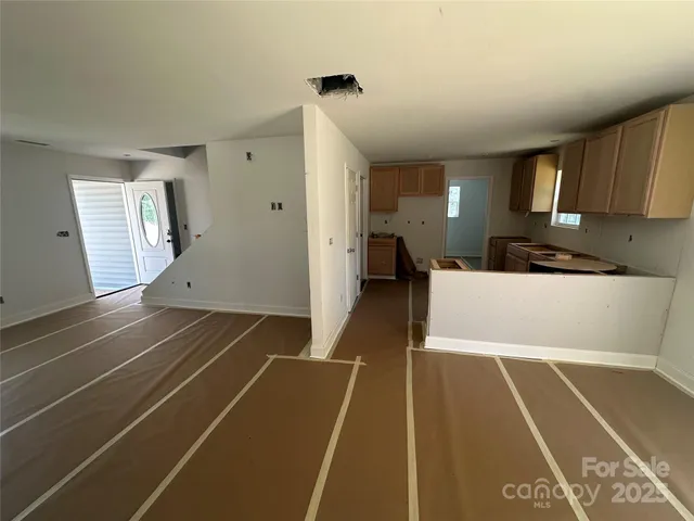 a view of a room with wooden floor and windows