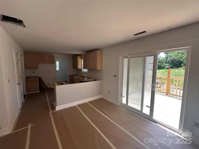 a view of a kitchen with a refrigerator a sink and dishwasher next to a window