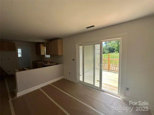 a kitchen with a refrigerator and windows