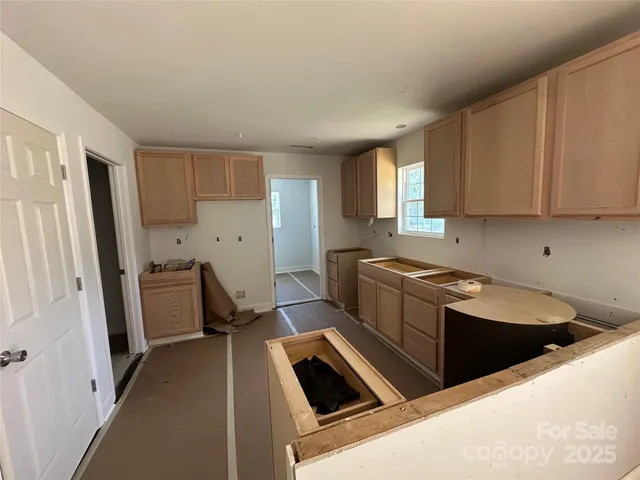 a kitchen that has a sink and a stove in it