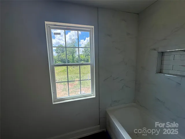 a bath tub sitting next to a window