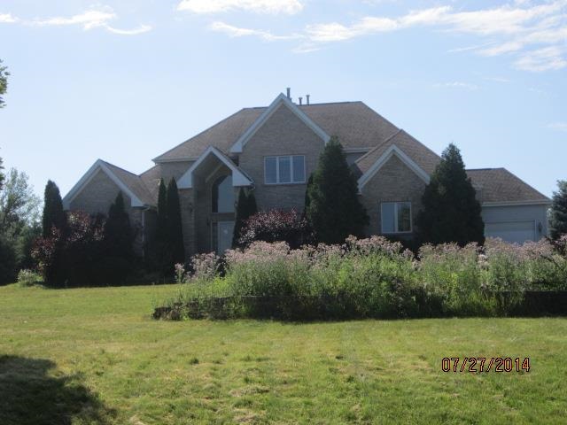 11545 Prestwick Road Belvidere, IL 61008 - Photo 1 of 14 a front view of a house with garden