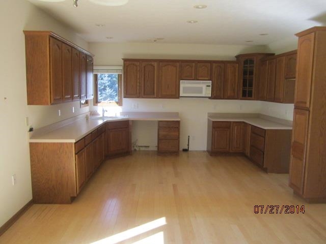 11545 Prestwick Road Belvidere, IL 61008 - Photo 4 of 14 a kitchen with stainless steel appliances granite countertop a sink and cabinets