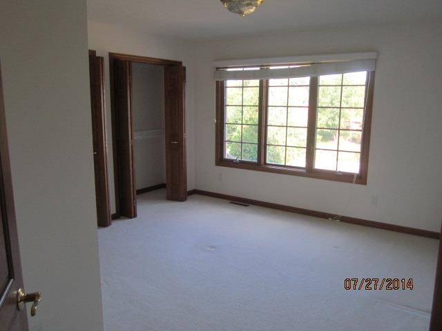11545 Prestwick Road Belvidere, IL 61008 - Photo 9 of 14 an empty room with windows