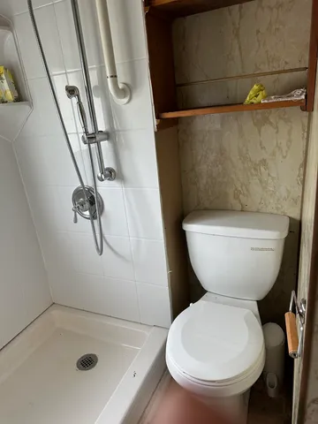 a bathroom with a toilet and a shower