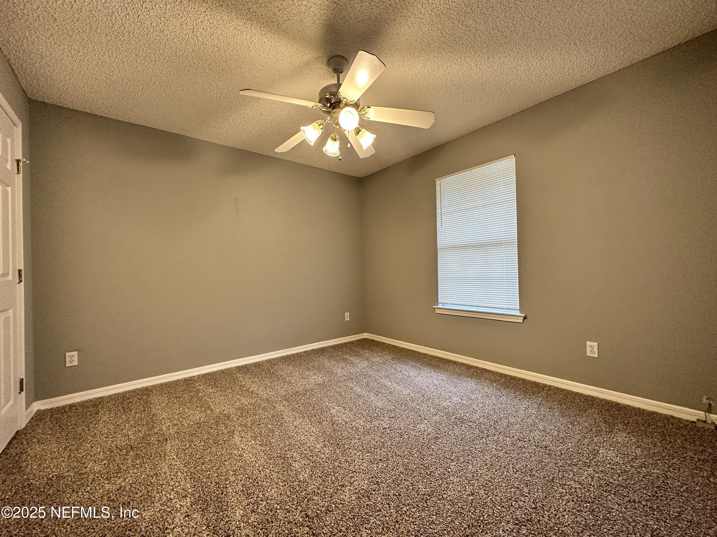 2478 Aloha Lane Middleburg, FL 32068 - Photo 12 of 16 an empty room with a window and a ceiling fan