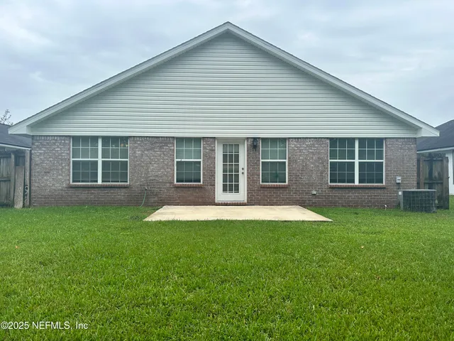 a view of a house with a backyard