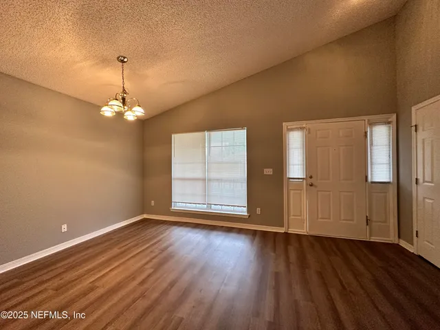 a view of wooden floor and windows in a room
