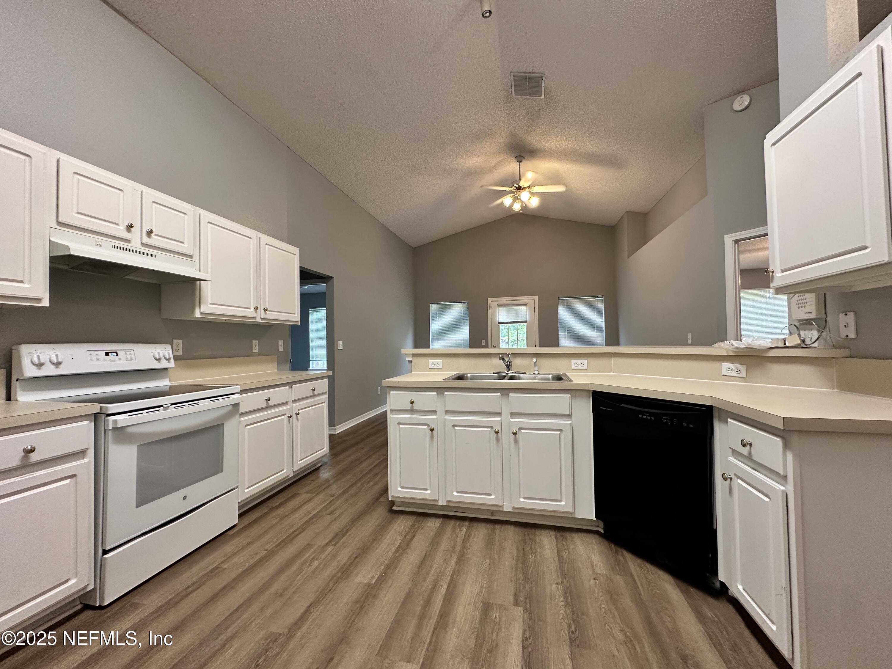 2478 Aloha Lane Middleburg, FL 32068 - Photo 5 of 16 a kitchen with a sink stove and cabinets