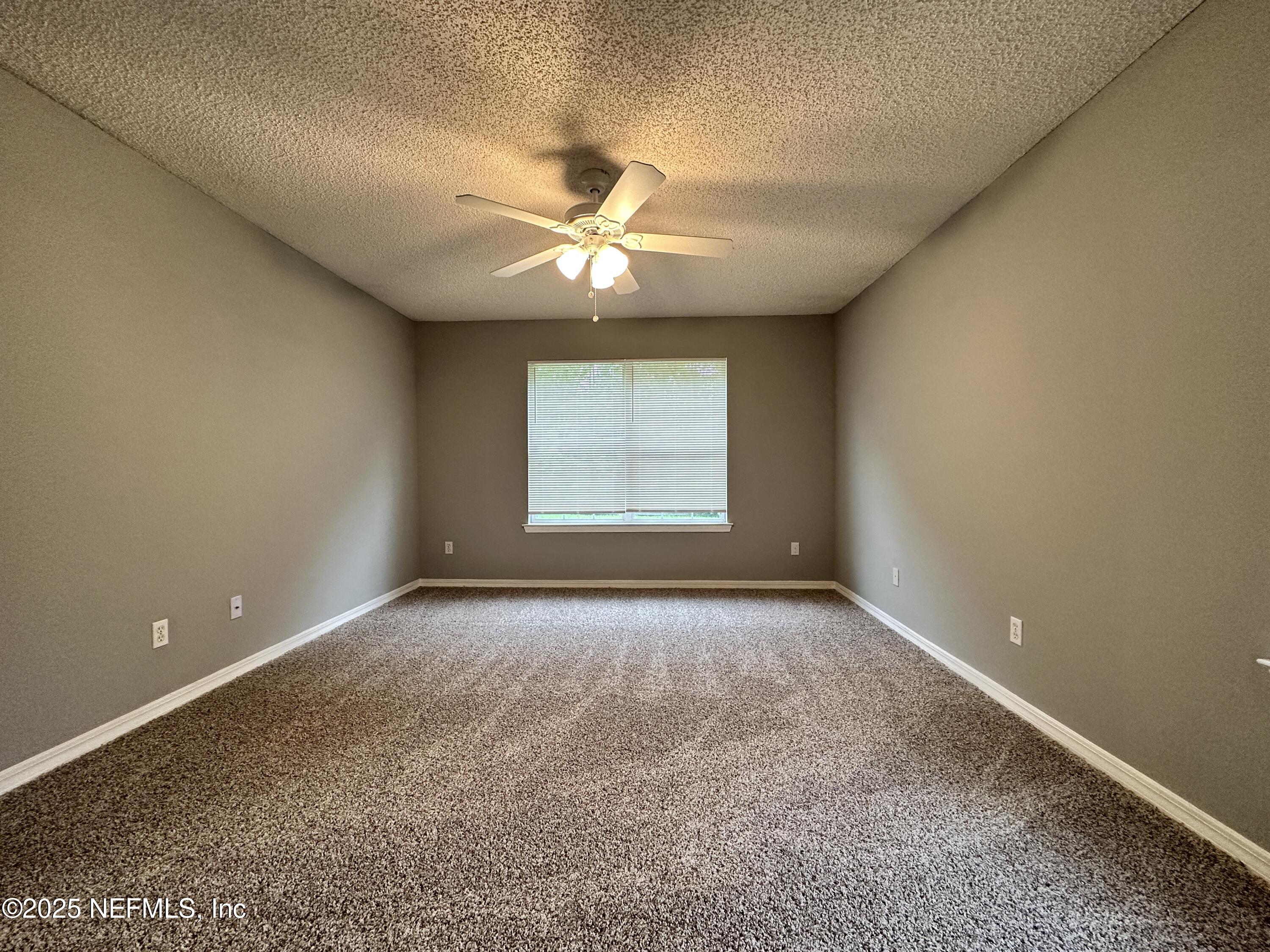 2478 Aloha Lane Middleburg, FL 32068 - Photo 9 of 16 an empty room with windows and fan