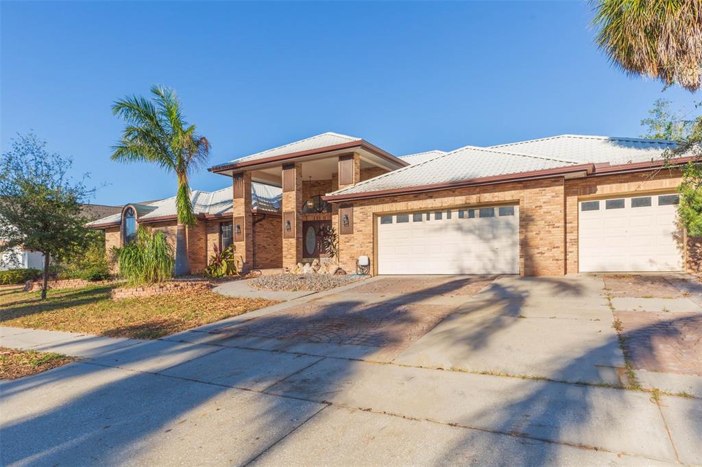 937 Bunker View Drive Apollo Beach, FL 33572 - Photo 2 of 73 a view of a house with a yard and a garage