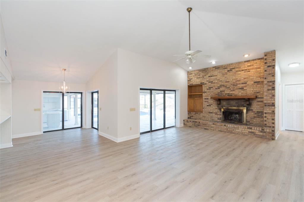 937 Bunker View Drive Apollo Beach, FL 33572 - Photo 29 of 73 a view of an empty room with wooden floor fireplace and a window