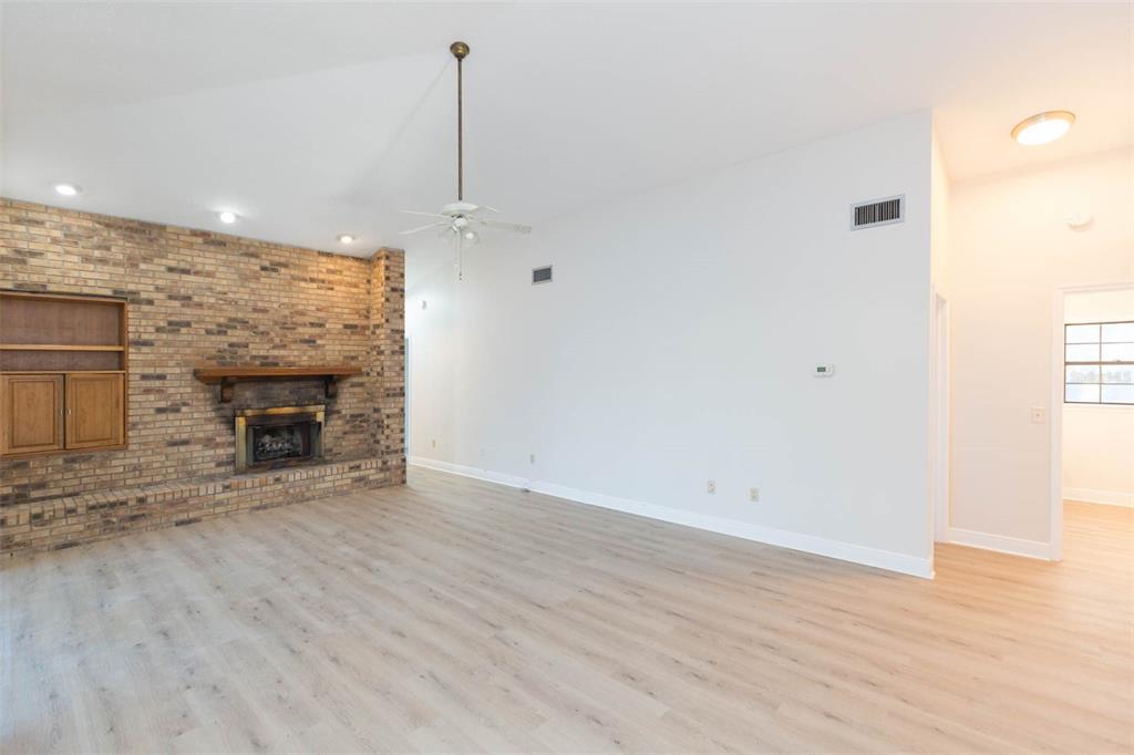 937 Bunker View Drive Apollo Beach, FL 33572 - Photo 32 of 73 an empty room with wooden floor fireplace and windows